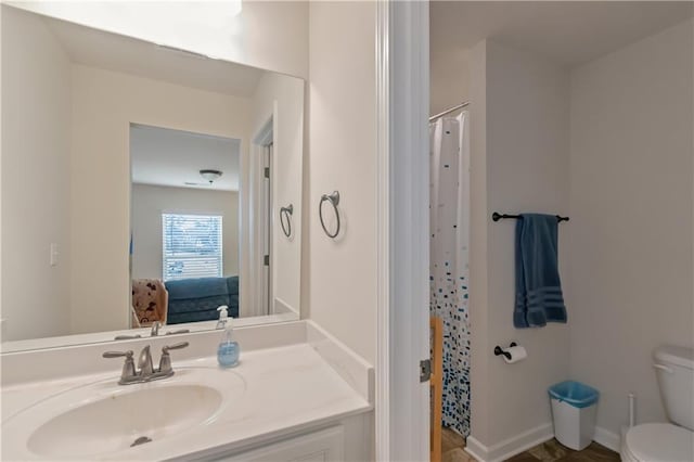 bathroom featuring vanity and toilet