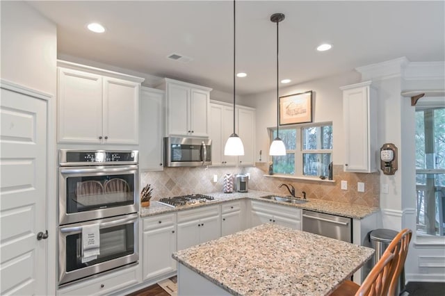 kitchen with white cabinetry, appliances with stainless steel finishes, and sink