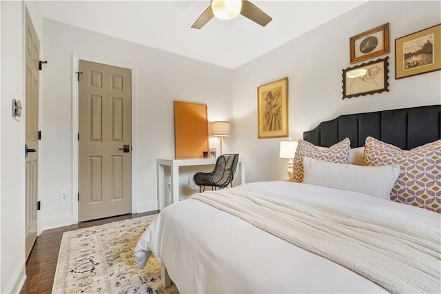 bedroom with ceiling fan and dark hardwood / wood-style flooring