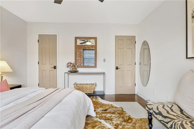 bedroom with dark hardwood / wood-style flooring and ceiling fan