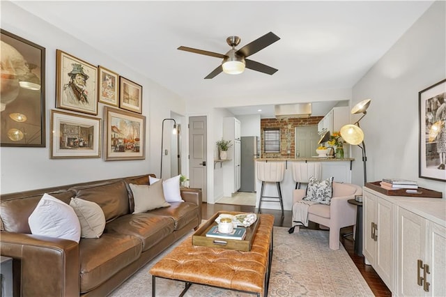 living room with ceiling fan and light hardwood / wood-style floors