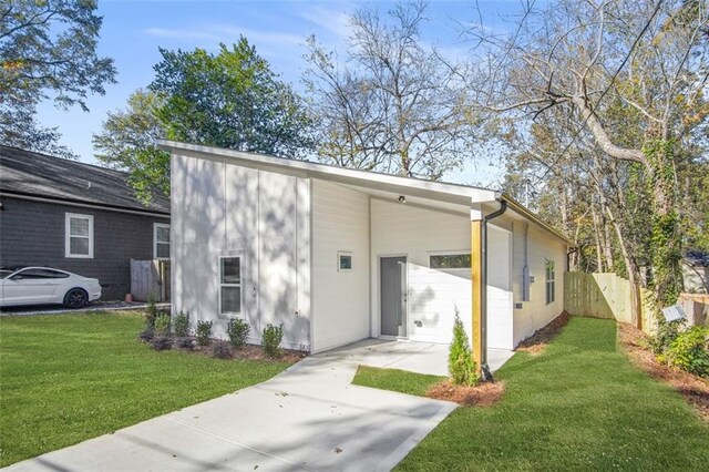 back of house with a lawn and a carport