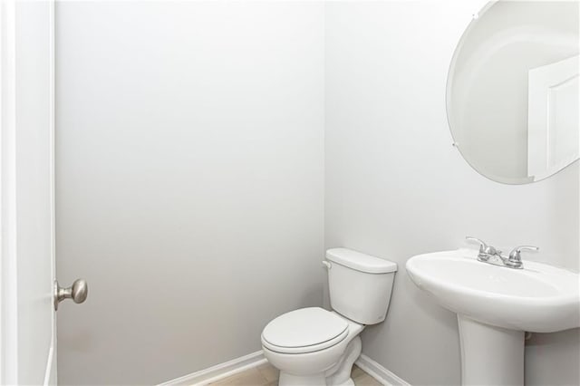 bathroom with toilet and tile patterned floors