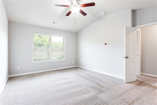 carpeted spare room with ceiling fan and lofted ceiling