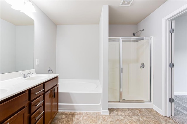 bathroom featuring vanity and shower with separate bathtub