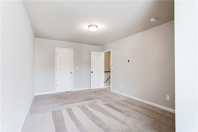 empty room featuring light carpet