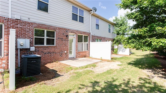 back of house featuring a yard, a patio, and central air condition unit