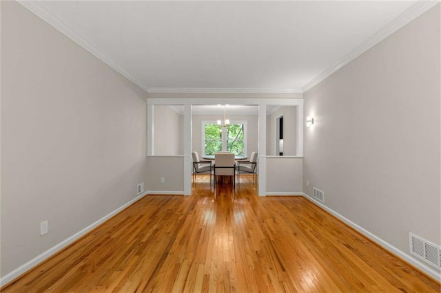 2892 Guinevere Dr NE, Atlanta, GA 30345 - empty room with light wood-style flooring, baseboards, ornamental molding, and a chandelier