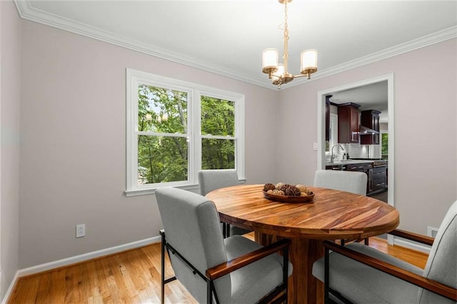 2892 Guinevere Dr NE, Atlanta, GA 30345 - dining room featuring baseboards, crown molding, a chandelier, and light wood-style flooring