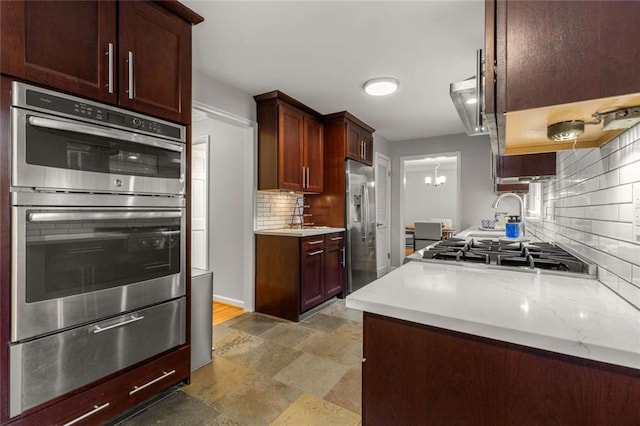 2892 Guinevere Dr NE, Atlanta, GA 30345 - kitchen with appliances with stainless steel finishes, a warming drawer, decorative backsplash, and light countertops