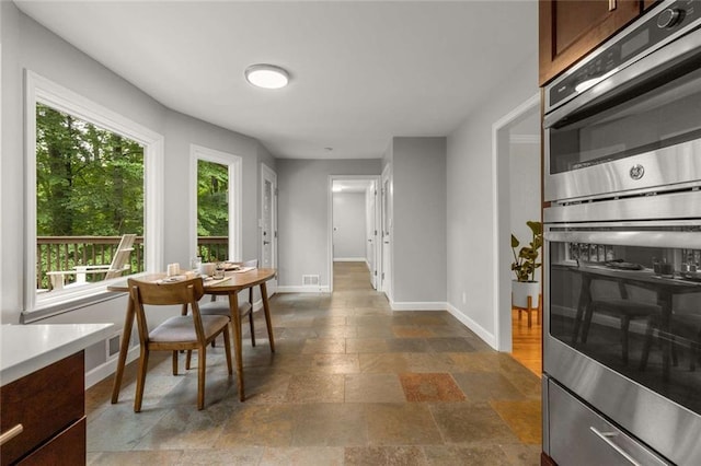 2892 Guinevere Dr NE, Atlanta, GA 30345 - dining room with baseboards and stone tile flooring