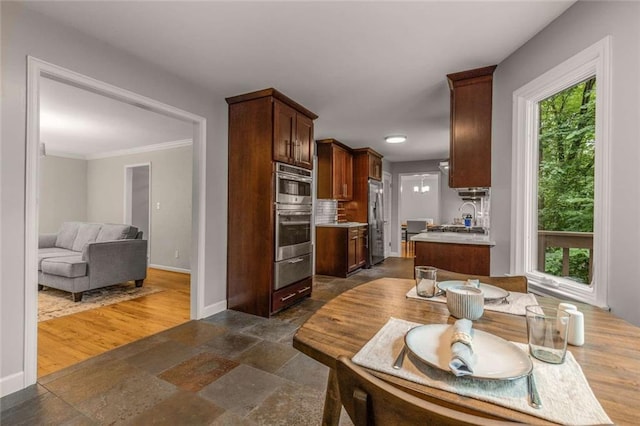 2892 Guinevere Dr NE, Atlanta, GA 30345 - kitchen featuring appliances with stainless steel finishes, baseboards, light countertops, stone tile flooring, and a warming drawer
