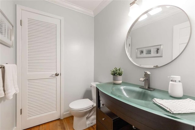 2892 Guinevere Dr NE, Atlanta, GA 30345 - bathroom with toilet, vanity, wood finished floors, and ornamental molding