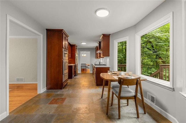 2892 Guinevere Dr NE, Atlanta, GA 30345 - dining space with baseboards, healthy amount of natural light, and stone finish flooring