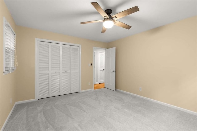 2892 Guinevere Dr NE, Atlanta, GA 30345 - unfurnished bedroom featuring light carpet, baseboards, a closet, and a ceiling fan