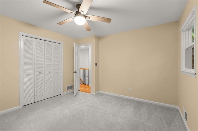 2892 Guinevere Dr NE, Atlanta, GA 30345 - unfurnished bedroom featuring carpet flooring, baseboards, a closet, and ceiling fan