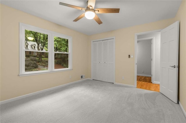 2892 Guinevere Dr NE, Atlanta, GA 30345 - unfurnished bedroom with carpet, baseboards, a closet, and ceiling fan