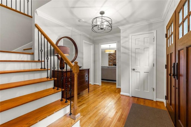 2892 Guinevere Dr NE, Atlanta, GA 30345 - foyer with stairs, wood finished floors, a chandelier, baseboards, and ornamental molding