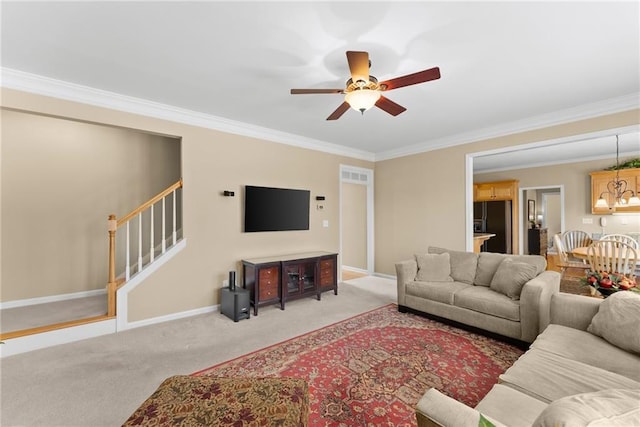 living area featuring light carpet, baseboards, a ceiling fan, stairway, and ornamental molding