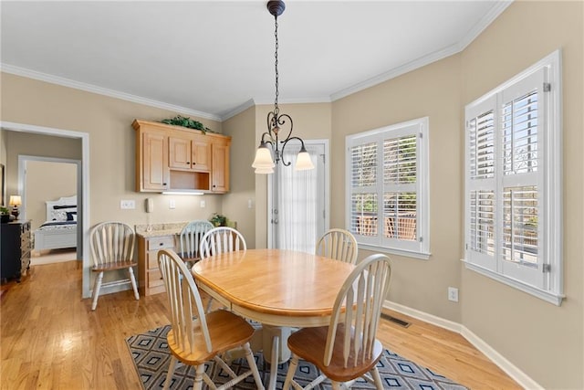 dining area with a chandelier, visible vents, baseboards, ornamental molding, and light wood finished floors