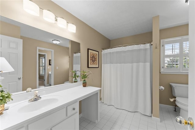 bathroom with toilet, tile patterned flooring, a textured ceiling, and vanity