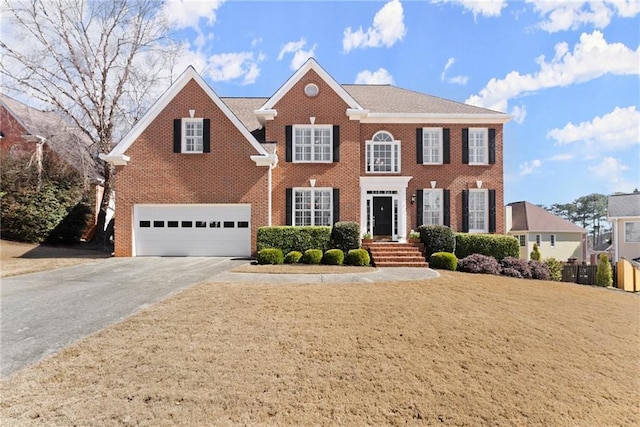 view of front of house featuring a garage, concrete driveway, and brick siding