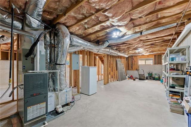 basement with electric panel and heating unit