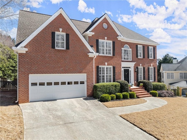 view of front of property with concrete driveway, brick siding, fence, and an attached garage