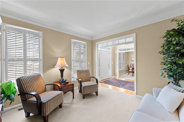 sitting room with a wealth of natural light and crown molding