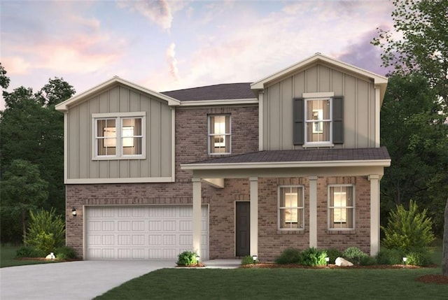 view of front of home with board and batten siding, brick siding, concrete driveway, and a garage