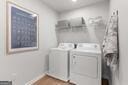 laundry room featuring washing machine and clothes dryer, laundry area, and baseboards