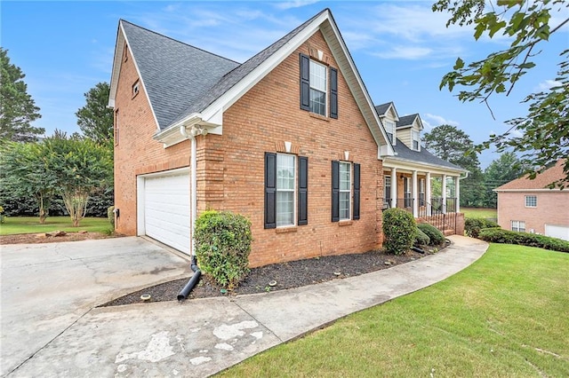 view of home's exterior featuring a lawn, a porch, and a garage