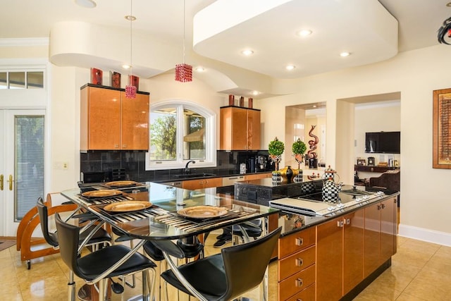 kitchen with light tile patterned floors, black electric cooktop, sink, and decorative backsplash