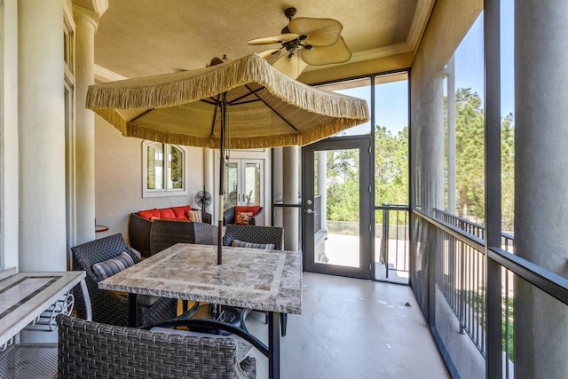 sunroom featuring a healthy amount of sunlight and ceiling fan