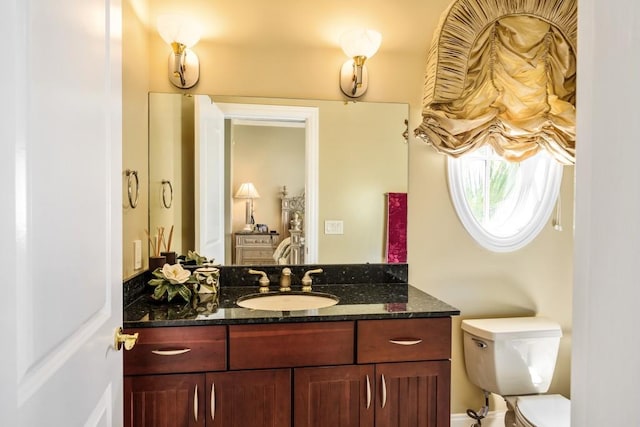 bathroom with toilet and vanity