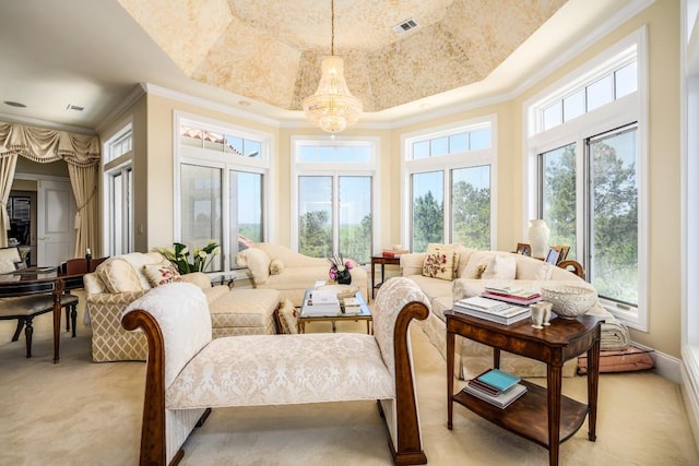 sunroom / solarium with an inviting chandelier and a tray ceiling