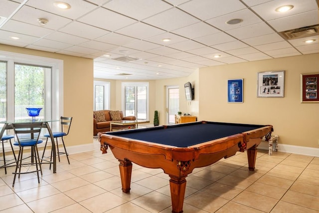 game room featuring a drop ceiling, pool table, and light tile patterned flooring