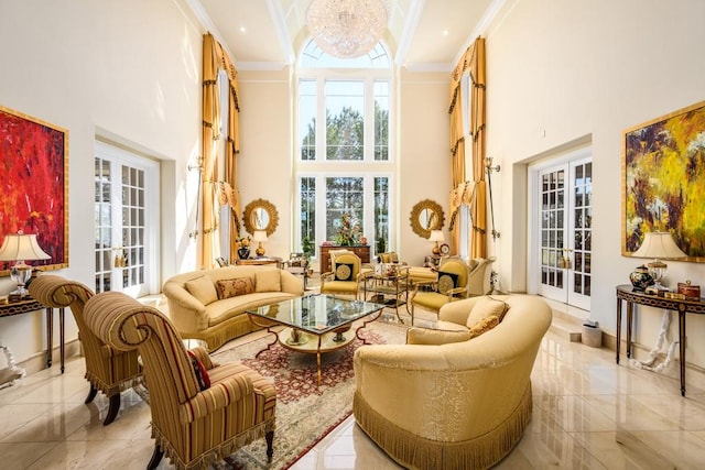 living room featuring a high ceiling, a notable chandelier, and ornamental molding