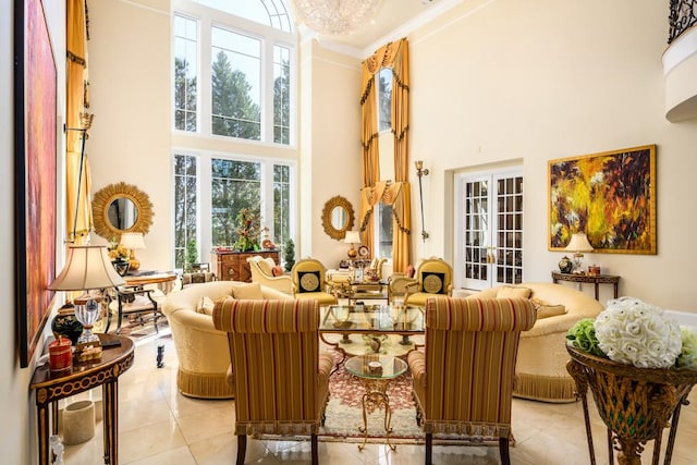 interior space with a towering ceiling, crown molding, and light tile patterned flooring