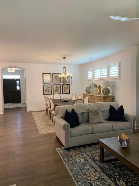 63 Aspen Way, Dallas, GA 30157 - living room with dark wood-type flooring, healthy amount of natural light, a chandelier, and baseboards