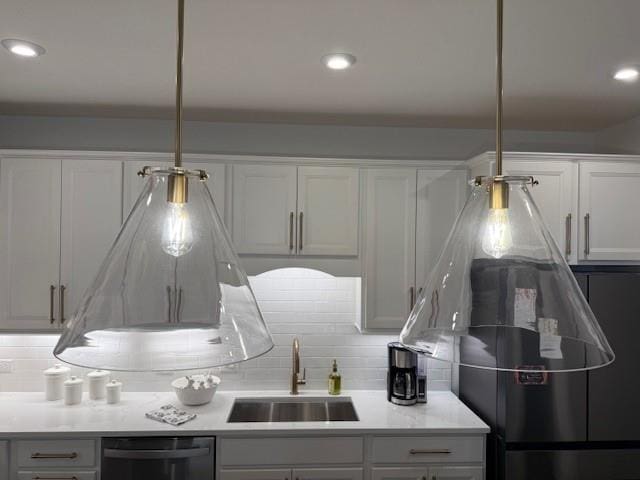 63 Aspen Way, Dallas, GA 30157 - kitchen with black dishwasher, a sink, decorative backsplash, fridge, and light countertops