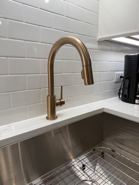 63 Aspen Way, Dallas, GA 30157 - kitchen view of a sink, decorative backsplash, and light stone countertops