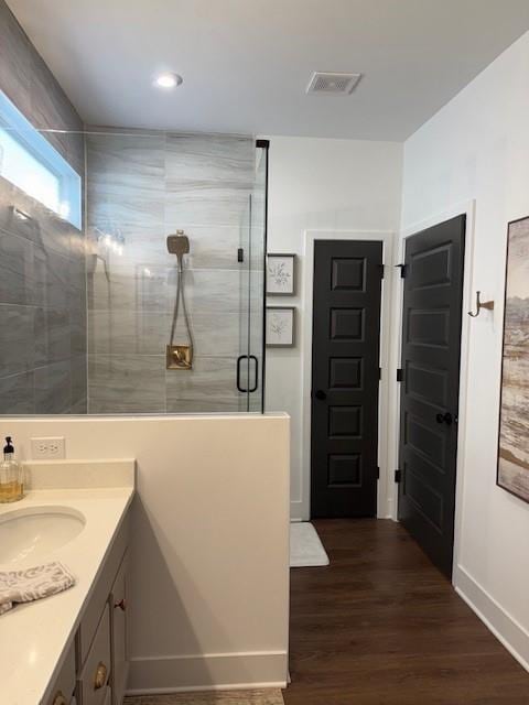 63 Aspen Way, Dallas, GA 30157 - full bathroom with a shower stall, wood finished floors, vanity, baseboards, and recessed lighting