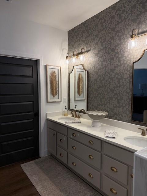 63 Aspen Way, Dallas, GA 30157 - full bath with double vanity, wood finished floors, and wallpapered walls