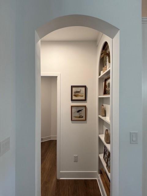 63 Aspen Way, Dallas, GA 30157 - hall featuring dark wood-style floors, arched walkways, built in shelves, and baseboards
