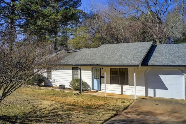 ranch-style house with a shingled roof, driveway, an attached garage, and a porch