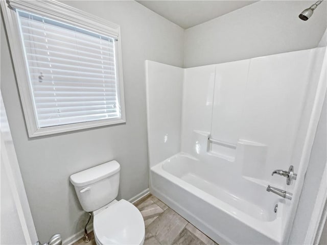 bathroom featuring toilet and washtub / shower combination