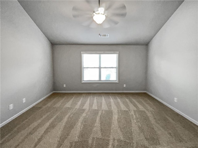 carpeted spare room featuring ceiling fan