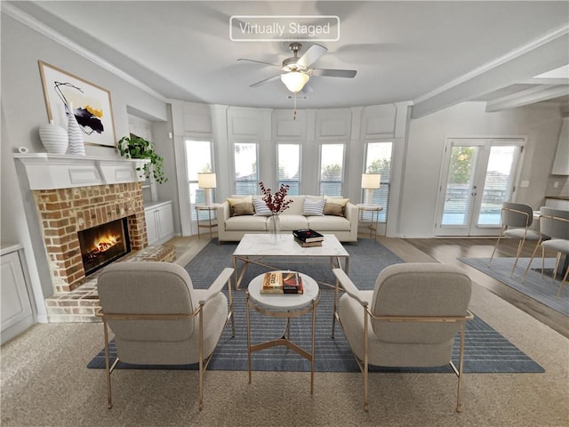 living room featuring french doors, a brick fireplace, and ceiling fan