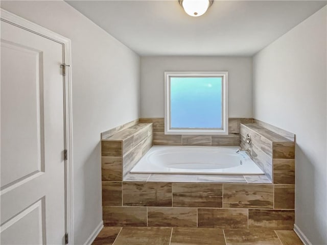 bathroom with tiled tub